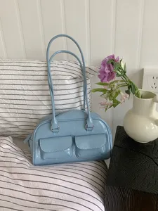 Blue patent leather shoulder bag for women, stylish daily tote bag with double handles and pockets.