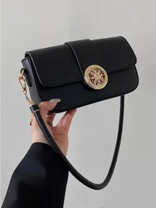 Elegant black leather shoulder bag with chic gold ornate clasp and chain detail for women.