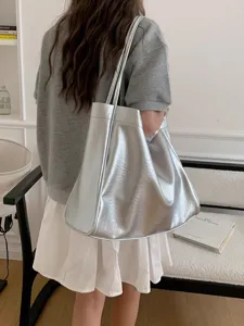 Detail view of silver metallic slouchy tote bag, large capacity shoulder bag for daily commute.