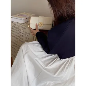 Vintage off-white shoulder bag for women, chic retro design handbag with gold round clasp.