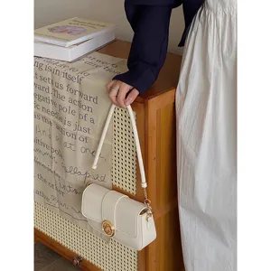 Chic minimalist white underarm shoulder bag with gold hardware and elegant retro flap design.