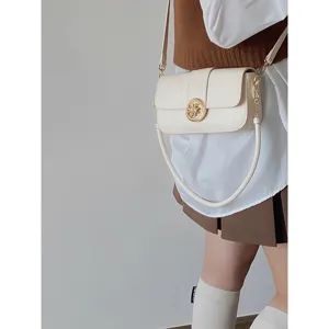 Chic retro cream shoulder bag for women, elegant crossbody bag with stylish gold hardware.