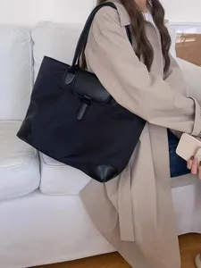 Large capacity women commuter nylon tote bag with leather flap and corner reinforcement style.