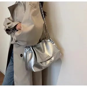 Silver metallic shoulder bag with chain strap, stylish autumn winter fashion accessory.