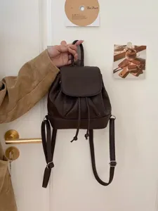 Dark brown mini backpack detail, faux leather daily casual purse close-up display.