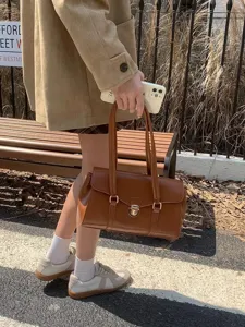 Retro women briefcase tote bag detail shot showing high quality PU leather and metal lock clasp.