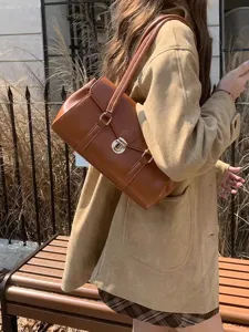 Vintage brown leather shoulder bag for women, chic underarm tote bag for daily commute and style.