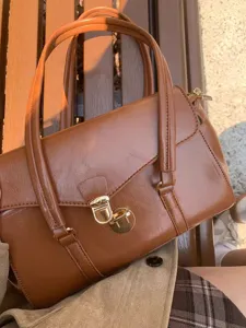 Vintage brown commuter handbag detail view, elegant retro PU leather tote bag for women.