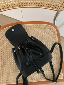 Black faux leather mini backpack for women, casual daily travel small book bag and daypack.