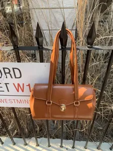Retro brown underarm shoulder bag detailed view, showcasing premium leather texture and hardware.