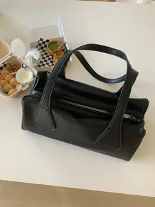 Chic black shoulder bag for women, retro baguette cylinder design, versatile casual daily purse.