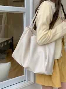 Casual large capacity soft leather tote bag for women daily commute shoulder bag in beige.