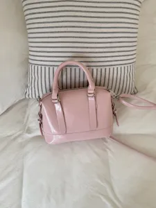 Pink bowling handbag for women, PU leather retro crossbody bag, stylish commuter shoulder bag.