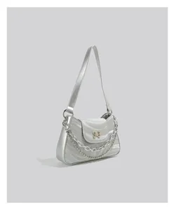 Silver metallic baguette shoulder bag featuring a stylish chain and a cute butterfly decor.