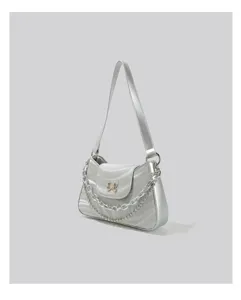 Silver metallic baguette shoulder bag detail featuring a butterfly charm and layered chain strap.