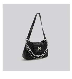 Black baguette underarm shoulder bag showcasing chic metal chain and elegant butterfly detail.