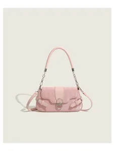 Pink quilted shoulder bag detail featuring metal lock closure and chain strap handle.