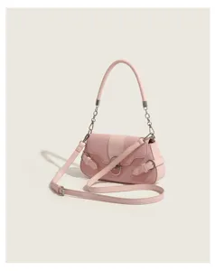 Pink quilted shoulder bag detail with chain handle and stylish metal buckle closure.