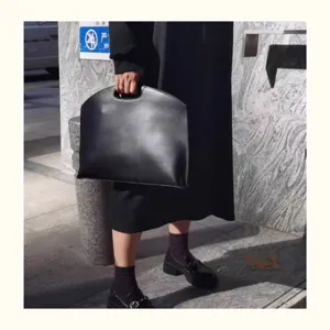 Minimalist black laptop handbag for women, slim 13 inch office commute work document tote bag.