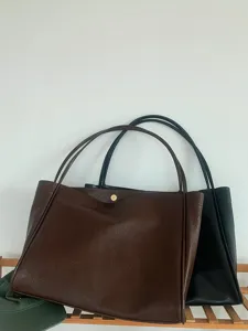 Detailed shot of large capacity soft leather tote shoulder bag in stylish colors.