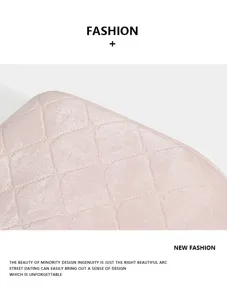 Close-up detail of women quilted handbag in pink leather with elegant bow diamond pattern.