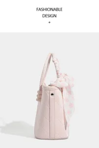 Pink quilted handbag detail featuring a stylish floral print twilly scarf handle.