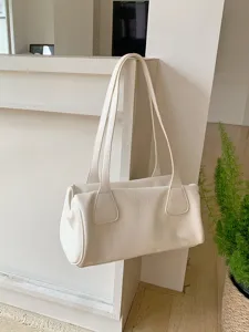 Minimalist white shoulder bag detail shot, vintage chic baguette purse texture and strap.