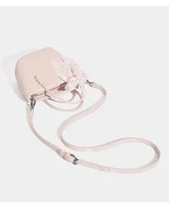 Pink quilted crossbody bag detail, featuring adjustable strap and floral ribbon charm.