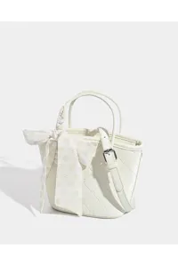 White quilted bucket handbag for women, featuring a floral scarf and crossbody strap.