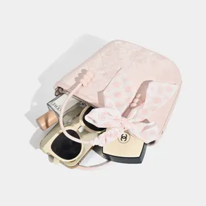 Pink quilted bucket bag with ribbon bow, chic casual crossbody handbag for women.