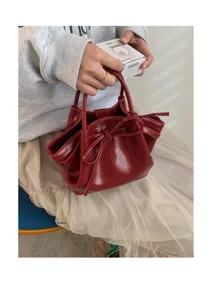 Borsa a secchiello in pelle verniciata rossa con fiocco, elegante borsa da donna.