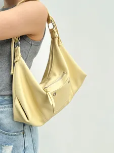 Trendy yellow slouchy hobo shoulder bag, vintage motorcycle style underarm tote purse.