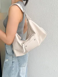 Vintage style motorcycle shoulder bag for women, chic underarm hobo bag with front zip pocket.