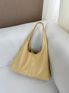 Soft leather yellow shoulder bag detail view, casual hobo purse design, daily commuting style.