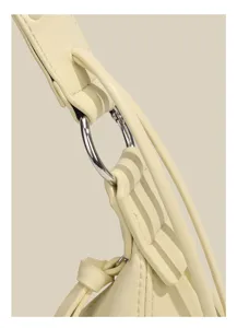 Detailed shot of yellow leather shoulder bag strap with silver metal ring hardware and fine stitching.
