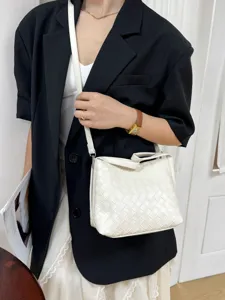 White woven bucket bag for women, chic leather shoulder crossbody bag with elegant design.