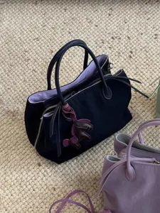 Niche design multi-compartment minimalist handbag, stylish nylon tote bag with cute animal charm.