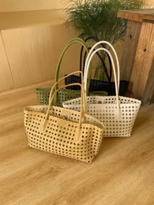 Woven hollow shoulder tote bag with double handles, premium fashion design for summer vacation.