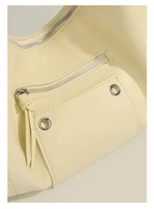Vintage motorcycle shoulder bag detail showing soft leather texture, zipper and grommet.