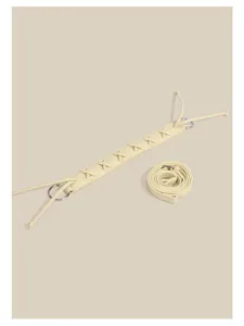 Beige leather bag strap detail featuring cross-laced design and metal rings for replacement.