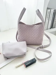 Detailed view of lavender woven bucket bag with matching pouch on clean white aesthetic surface.