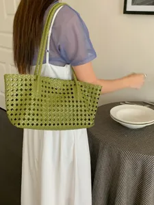 Green woven tote bag detail view, casual shoulder bag for summer vacation and daily commute use.