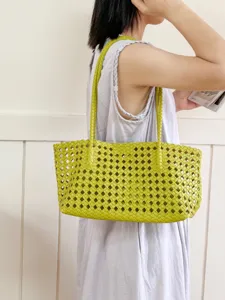Stylish yellow woven shoulder bag for women, large capacity hollow design casual tote bag.