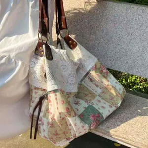 Detailed view of casual floral canvas tote bag with elegant lace splicing for daily commute.