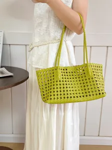 Chic lime green woven shoulder bag showcasing intricate grid cutout details and slim double straps.