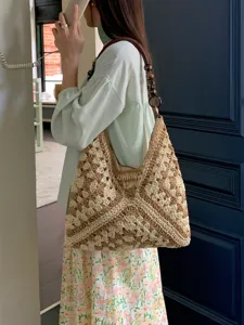 Detailed view of summer hollow crochet shoulder bag, vacation style woven tote with bead strap.