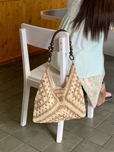 Chic summer hollow straw shoulder bag with wooden bead handles for beach vacation and daily wear.