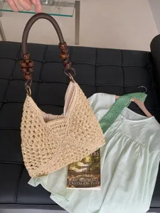 Summer straw woven shoulder bag for women, hollow out beach tote bag with wooden bead handle.