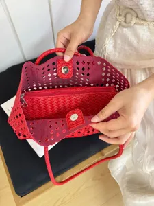 Red woven hollow-out tote bag interior detail, stylish summer shoulder bag for women.