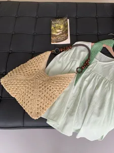 Summer straw woven shoulder bag, hollow out beach tote with beaded handle, casual vacation style.